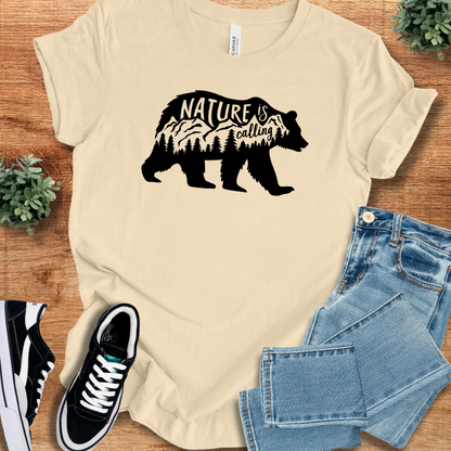 Heather-mauve t-shirt with '' text, flat lay styled on a wooden surface.