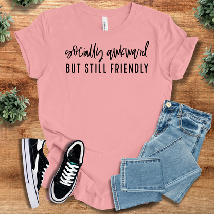 Heather-navy t-shirt with '' text, flat lay styled on a wooden surface.