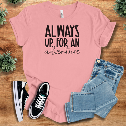Heather-mauve t-shirt with '' text, flat lay styled on a wooden surface.