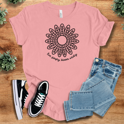 Heather-mauve t-shirt with '' text, flat lay styled on a wooden surface.