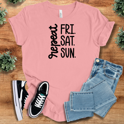 White t-shirt with '' text, flat lay styled on a wooden surface.