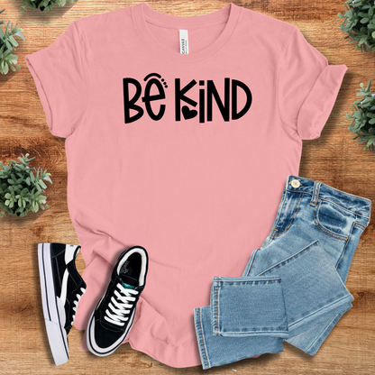 Heather-mauve t-shirt with '' text, flat lay styled on a wooden surface.