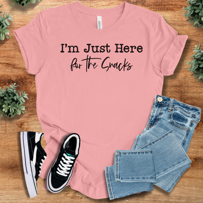 Heather-mauve t-shirt with '' text, flat lay styled on a wooden surface.