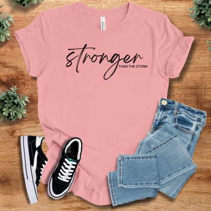 Heather-navy t-shirt with '' text, flat lay styled on a wooden surface.