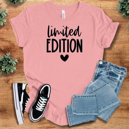 Heather-aqua t-shirt with '' text, flat lay styled on a wooden surface.