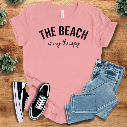 Heather-aqua t-shirt with '' text, flat lay styled on a wooden surface.