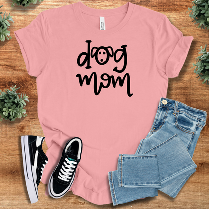 Heather-mauve t-shirt with '' text, flat lay styled on a wooden surface.