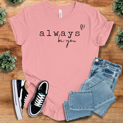 Heather-aqua t-shirt with '' text, flat lay styled on a wooden surface.