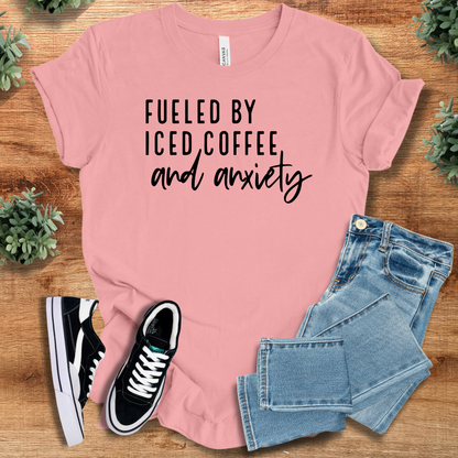 Heather-mauve t-shirt with '' text, flat lay styled on a wooden surface.