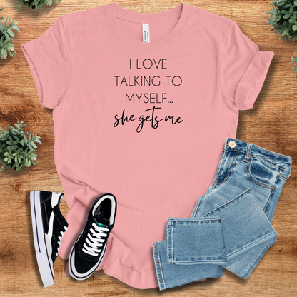 Soft-cream t-shirt with '' text, flat lay styled on a wooden surface.