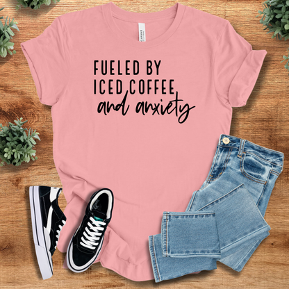 Heather-aqua t-shirt with '' text, flat lay styled on a wooden surface.
