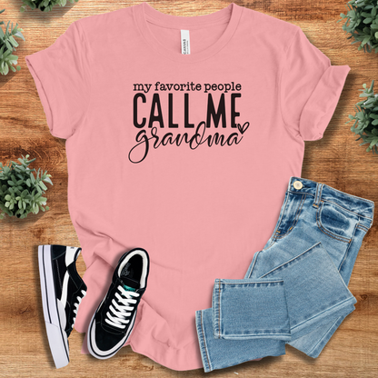 Heather-navy t-shirt with '' text, flat lay styled on a wooden surface.
