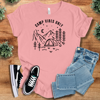 Heather-mauve t-shirt with '' text, flat lay styled on a wooden surface.