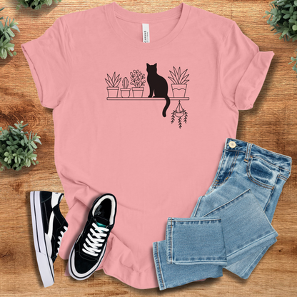 Heather-mauve t-shirt with '' text, flat lay styled on a wooden surface.