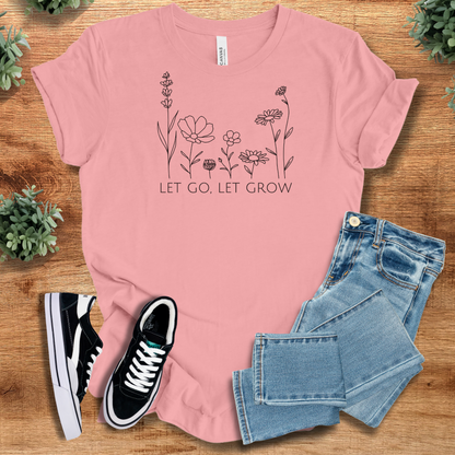 Athletic-heather t-shirt with '' text, flat lay styled on a wooden surface.
