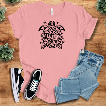 Heather-aqua t-shirt with '' text, flat lay styled on a wooden surface.