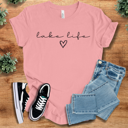 Heather-navy t-shirt with '' text, flat lay styled on a wooden surface.