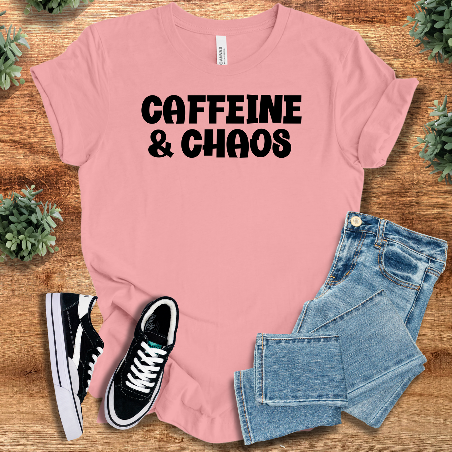 Heather-navy t-shirt with '' text, flat lay styled on a wooden surface.