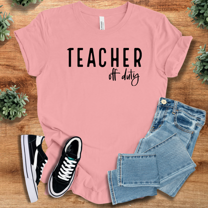 Heather-navy t-shirt with '' text, flat lay styled on a wooden surface.