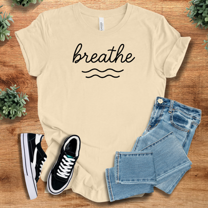 Athletic-heather t-shirt with '' text, flat lay styled on a wooden surface.