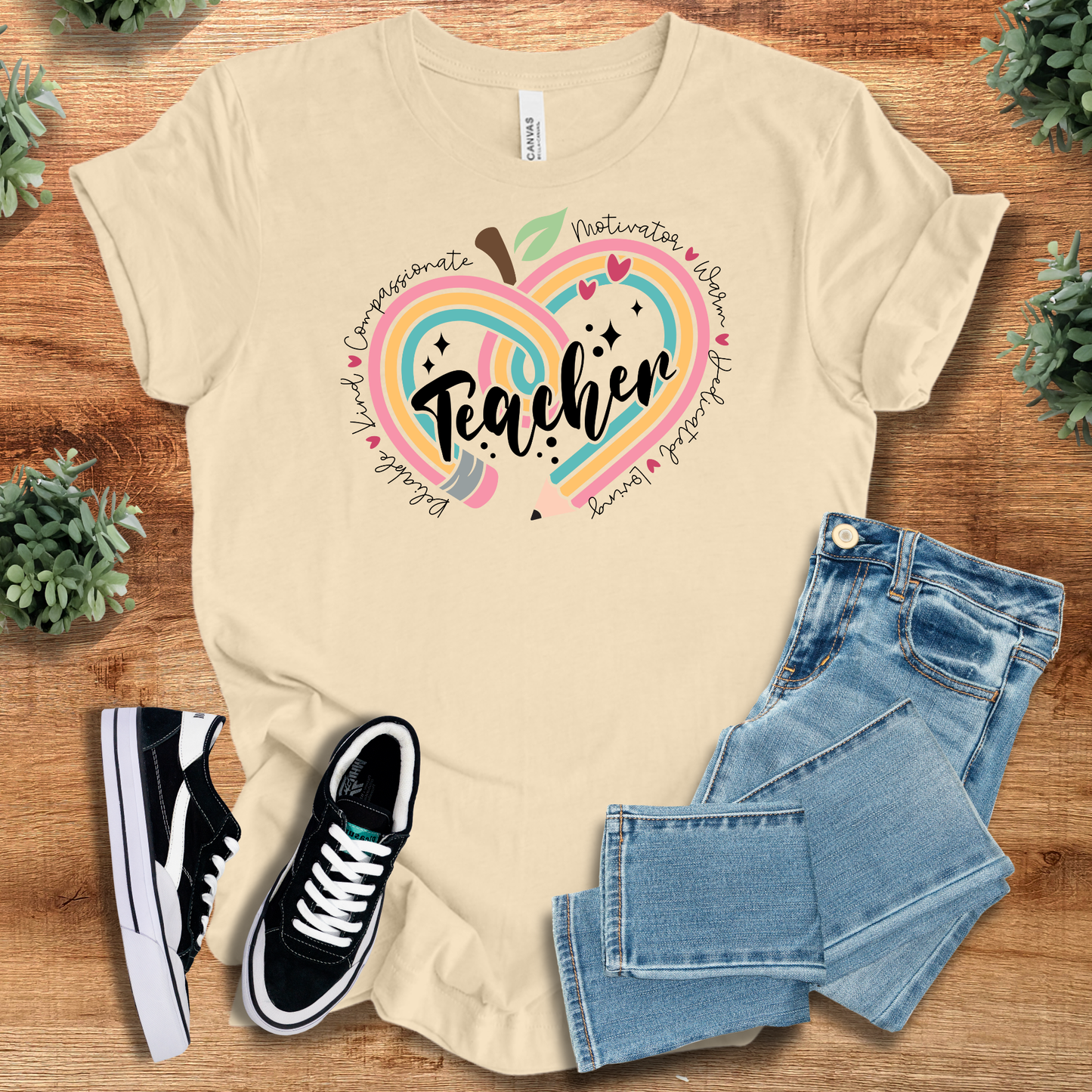 Cream Teacher Appreciation T-Shirt with vibrant heart-apple artwork and kind words. 100% cotton, retail fit tee perfect for teacher gifting.