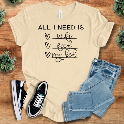 Heather-navy t-shirt with '' text, flat lay styled on a wooden surface.