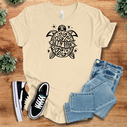 Athletic-heather t-shirt with '' text, flat lay styled on a wooden surface.