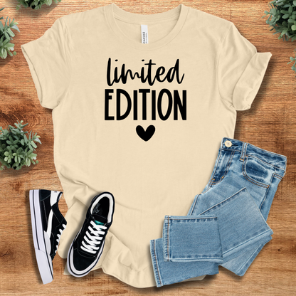 Athletic-heather t-shirt with '' text, flat lay styled on a wooden surface.