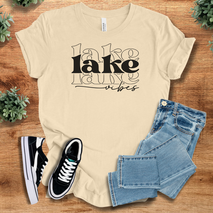 Heather-navy t-shirt with '' text, flat lay styled on a wooden surface.