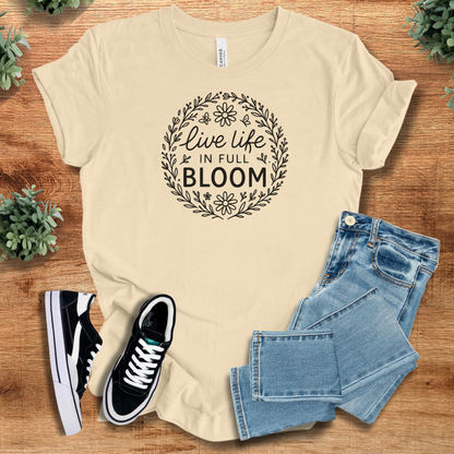Heather-aqua t-shirt with '' text, flat lay styled on a wooden surface.