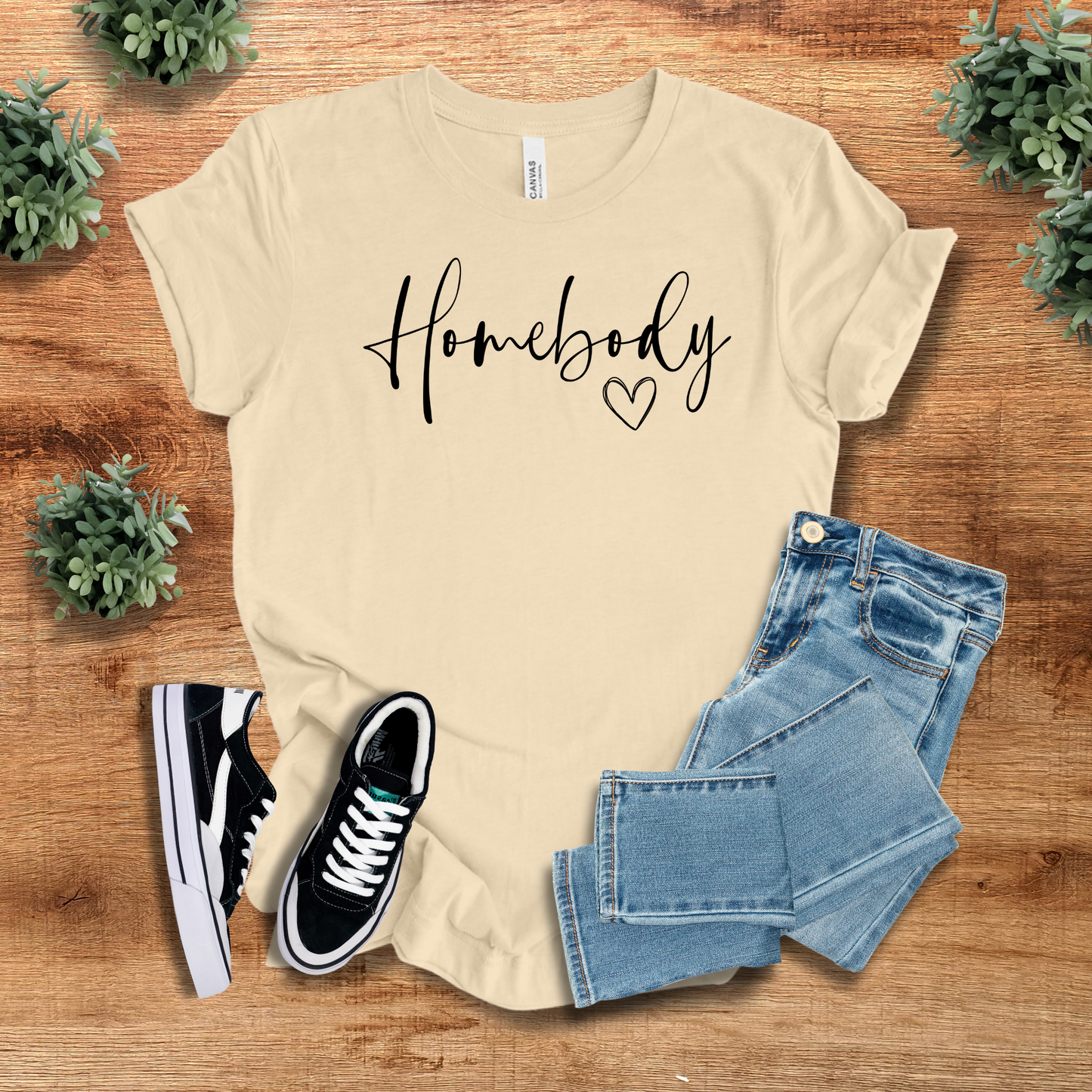 Beige Homebody Graphic T-Shirt with a minimalist aesthetic, paired with denim jeans and sneakers. A soft and breathable tee for everyday wear.