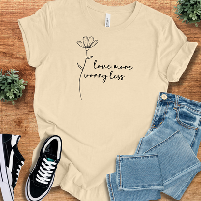 Heather-mauve t-shirt with '' text, flat lay styled on a wooden surface.