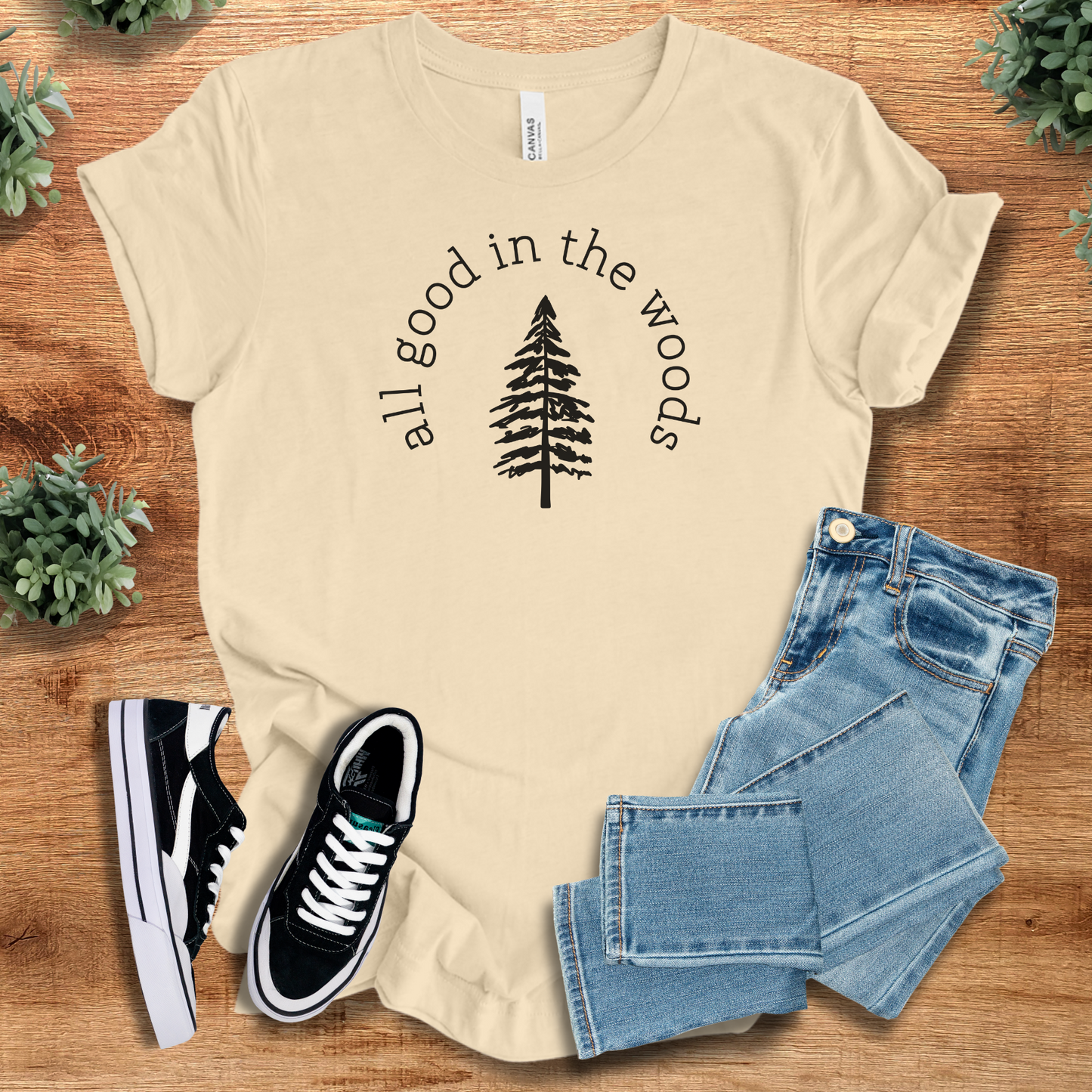 Heather-navy t-shirt with '' text, flat lay styled on a wooden surface.