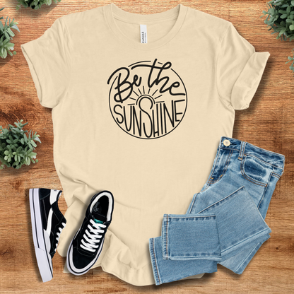 Athletic-heather t-shirt with '' text, flat lay styled on a wooden surface.
