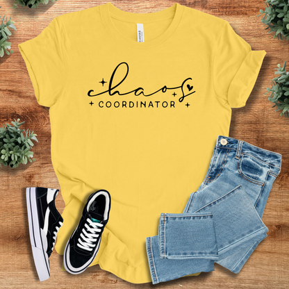 Military-green t-shirt with '' text, flat lay styled on a wooden surface.