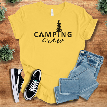 Military-green t-shirt with '' text, flat lay styled on a wooden surface.