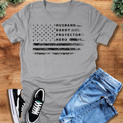 Heather-navy t-shirt with '' text, flat lay styled on a wooden surface.