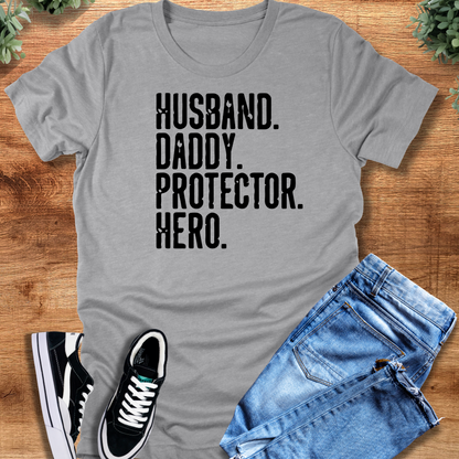 Heather-navy t-shirt with '' text, flat lay styled on a wooden surface.