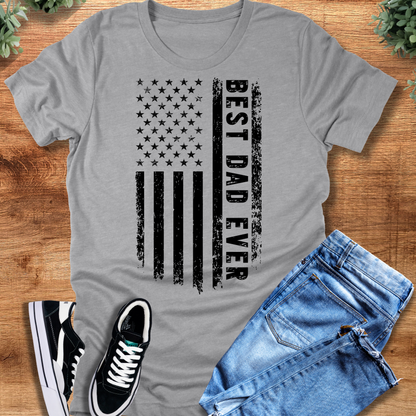 Black t-shirt with '' text, flat lay styled on a wooden surface.