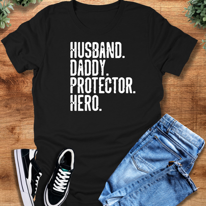 Heather-navy t-shirt with '' text, flat lay styled on a wooden surface.
