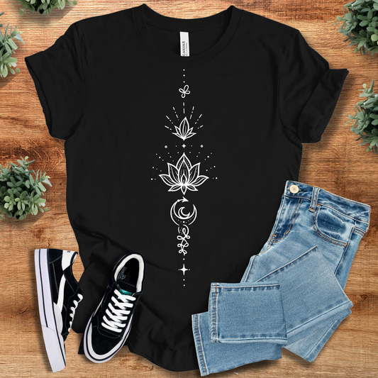 Black t-shirt with 'Lotus Tee' text, flat lay styled on a wooden surface.