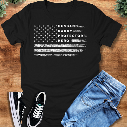 Heather-navy t-shirt with '' text, flat lay styled on a wooden surface.