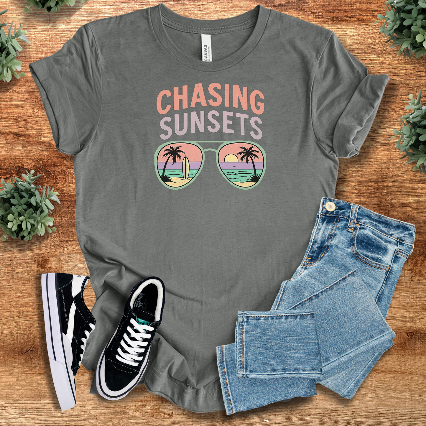 Heather-navy t-shirt with '' text, flat lay styled on a wooden surface.