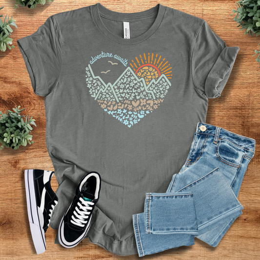 Adventure Awaits Heart - Adventure Mountain T-Shirt in heather gray featuring a heart and mountain graphic, perfect for travel and nature enthusiasts.