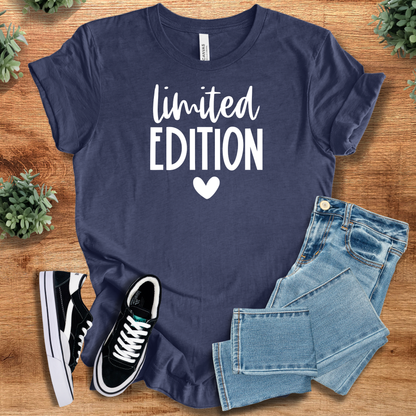 Heather-aqua t-shirt with '' text, flat lay styled on a wooden surface.