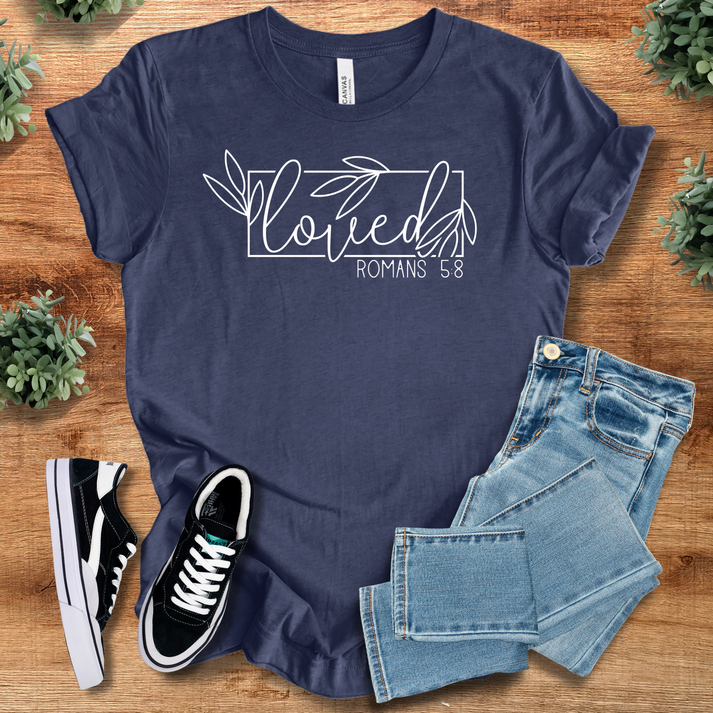 Navy blue Loved Romans 5:8 Christian Faith Tee with white floral script, perfect for casual outfits and religious gift ideas.