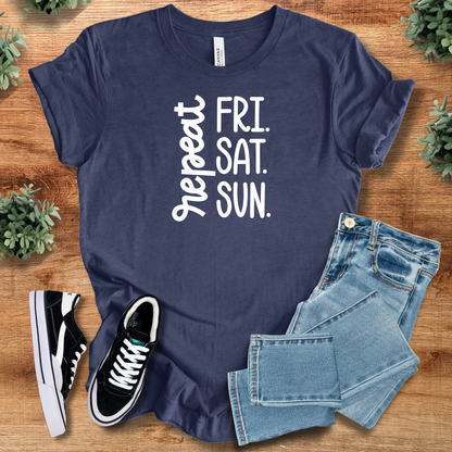 White t-shirt with '' text, flat lay styled on a wooden surface.