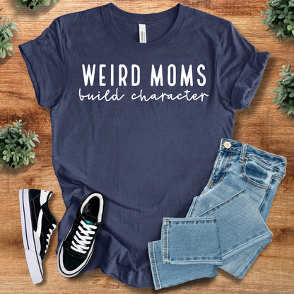 Heather-mauve t-shirt with '' text, flat lay styled on a wooden surface.