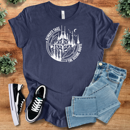 Pink t-shirt with '' text, flat lay styled on a wooden surface.