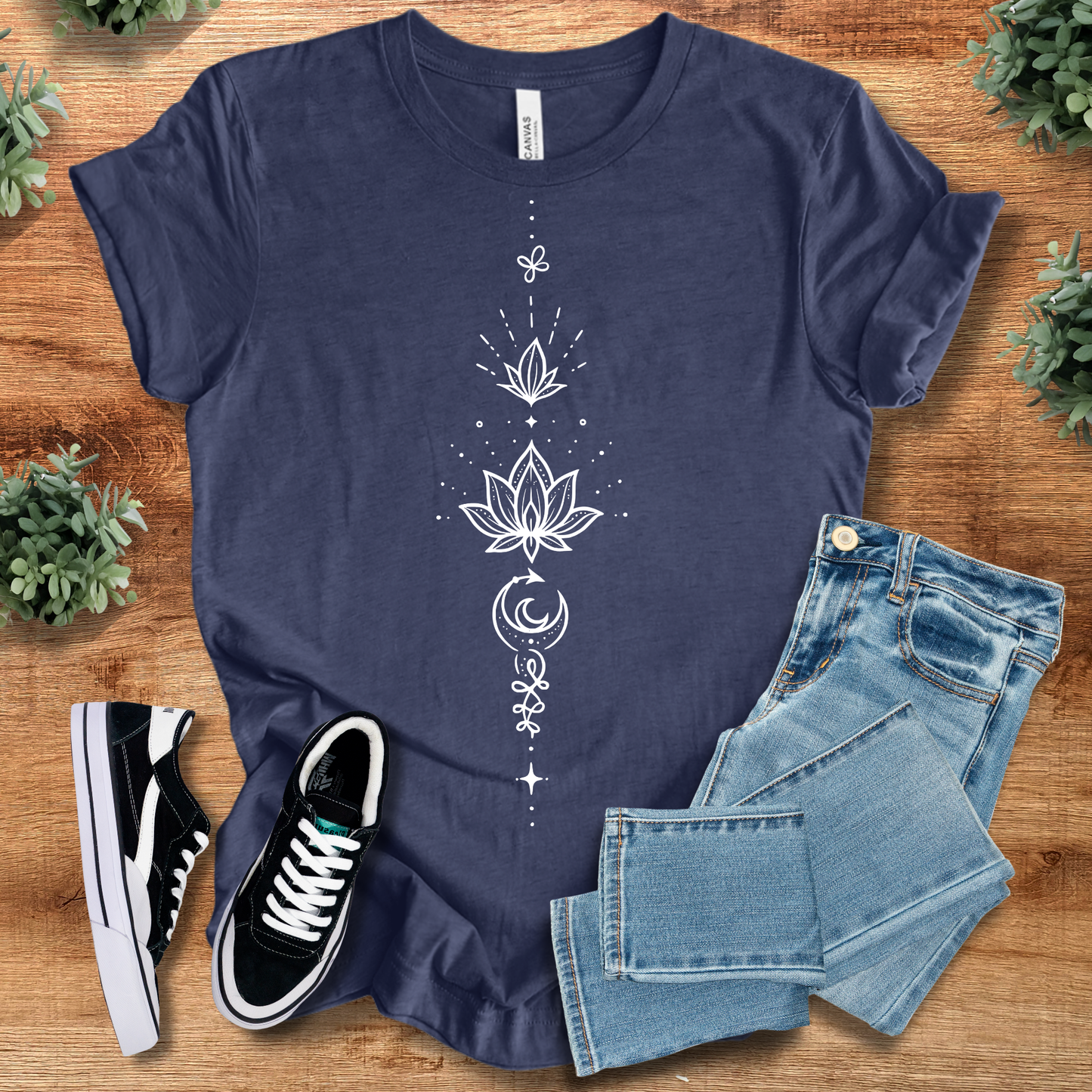 Heather-navy t-shirt with '' text, flat lay styled on a wooden surface.